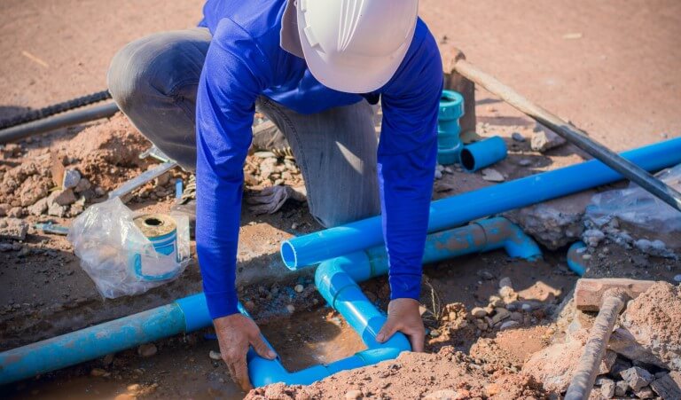 Construction worker,repairing a broken water pipe.